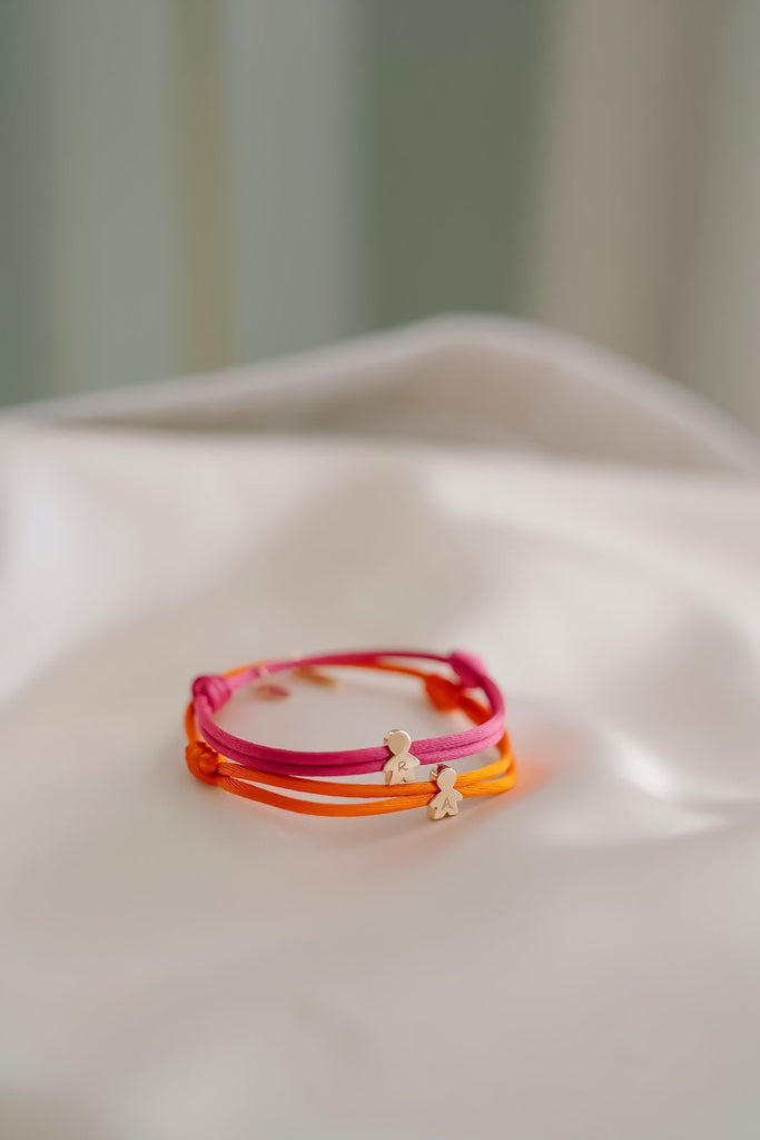 BRACCIALE E COLLANA IN TESSUTO CON CHARMS